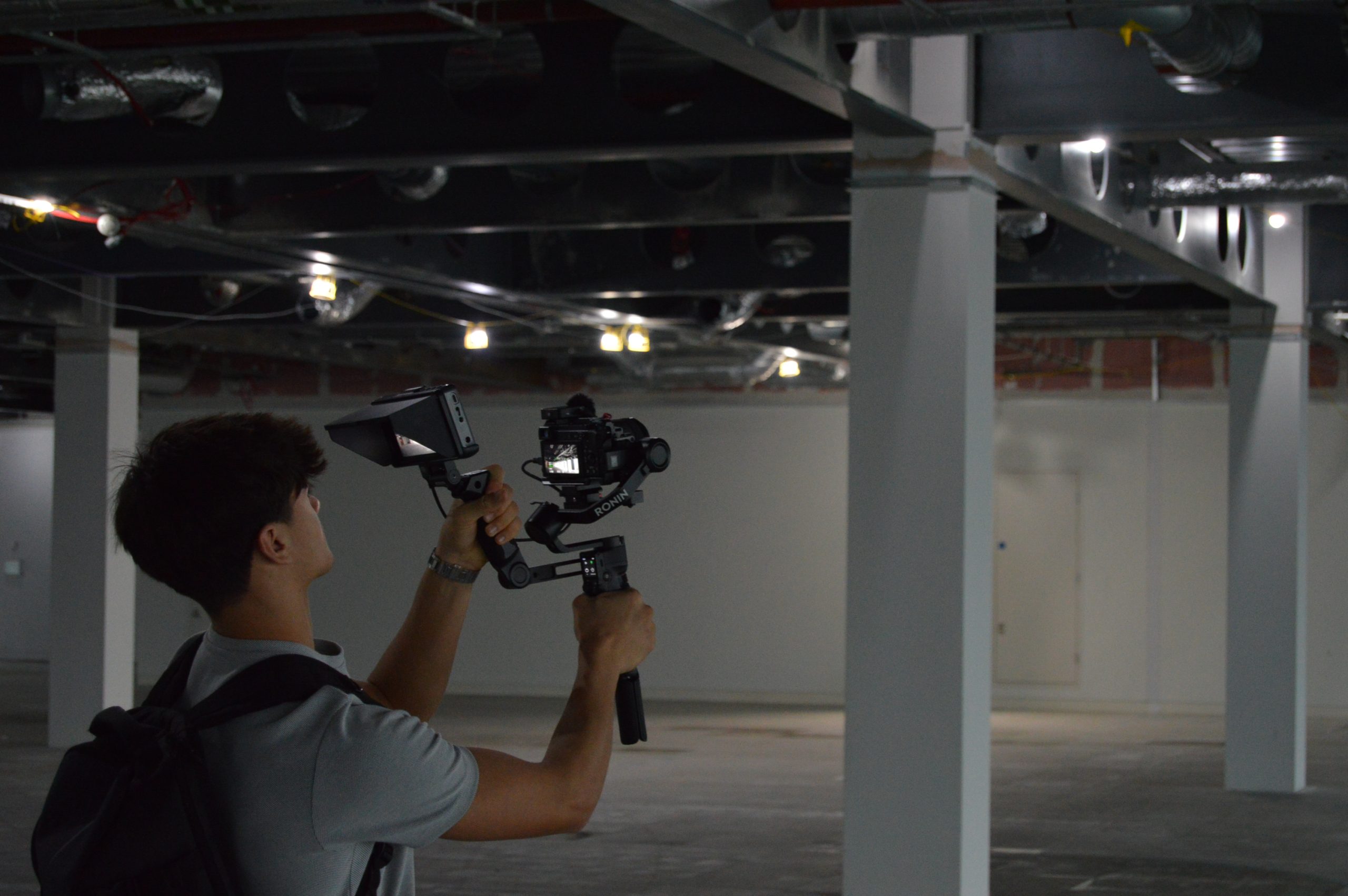 Maximum Impact videographer filming with a stabilised gimbal rig on location